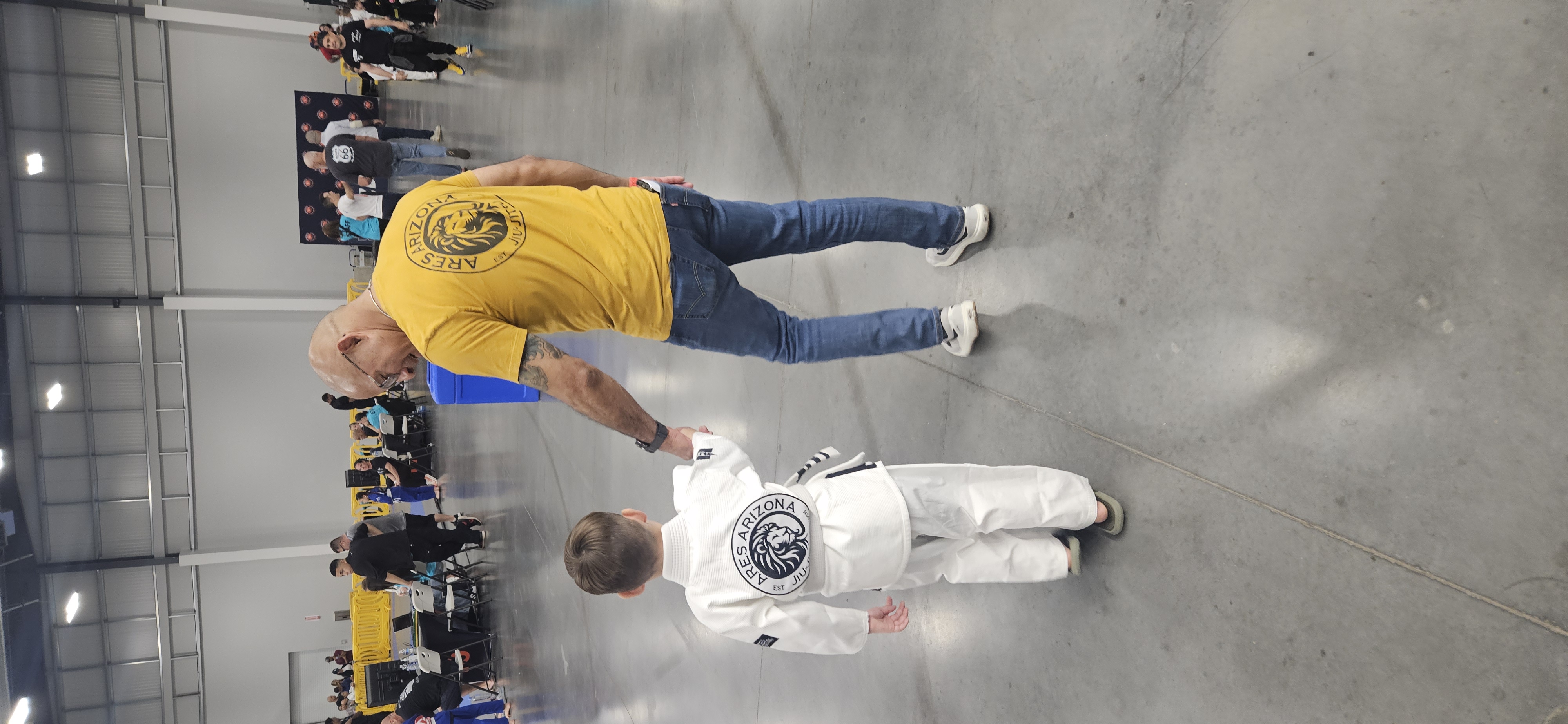 Coach with young competitor at tournament